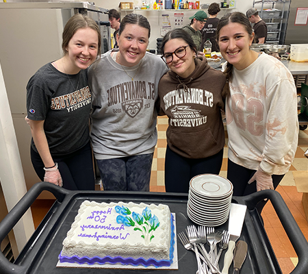 WH Anniversary cake and students